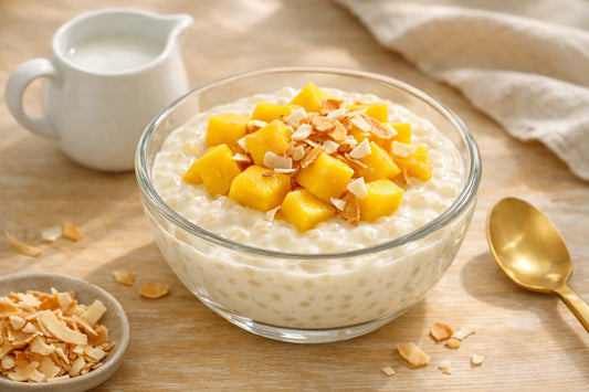 Vegan tapioca pudding — a creamy bowl of pudding topped with fresh mango and toasted coconut.