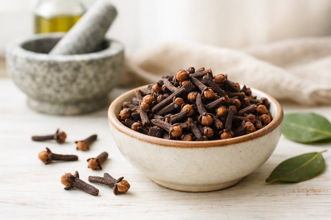 Cloves spice — whole dried cloves in a ceramic bowl with a mortar and pestle