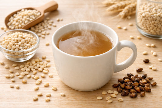 Barley beverage — steaming cup of barley coffee with scattered whole and roasted barley grains