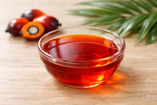 Red Palm Oil — vibrant red palm oil in a glass bowl with palm fruits