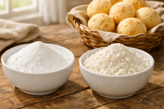 Polvilho Doce vs Azedo — two bowls of different cassava starches next to a basket of fresh pão de queijo.